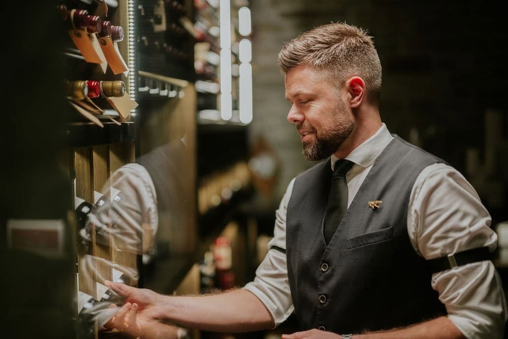 Waiter collects wine